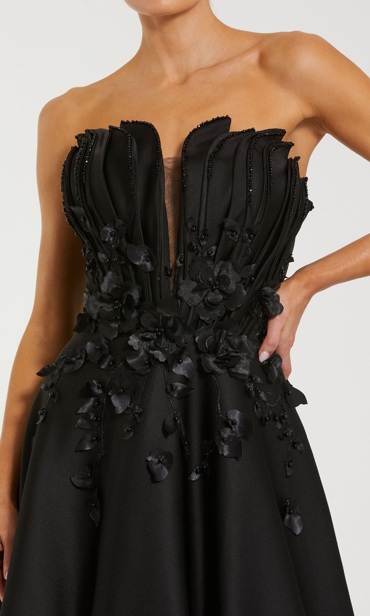 Black strapless dress with floral details on a white background